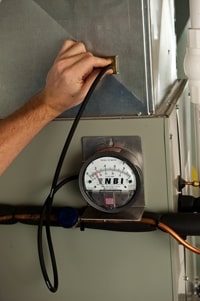 Man Peering into a Customer's Ductwork